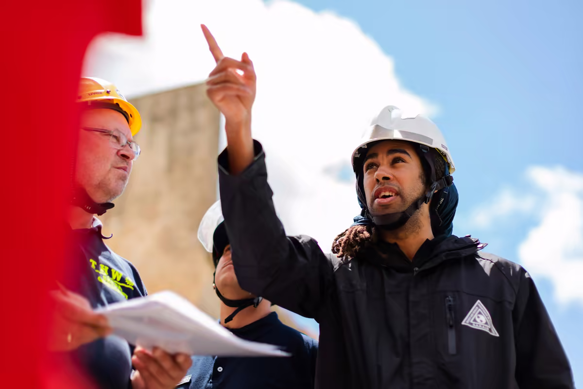 Team reviewing plans at a renewable energy project site